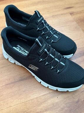 Skechers women’s size 8,NWOT, never worn, hands free, black w/white trim. COMFY!